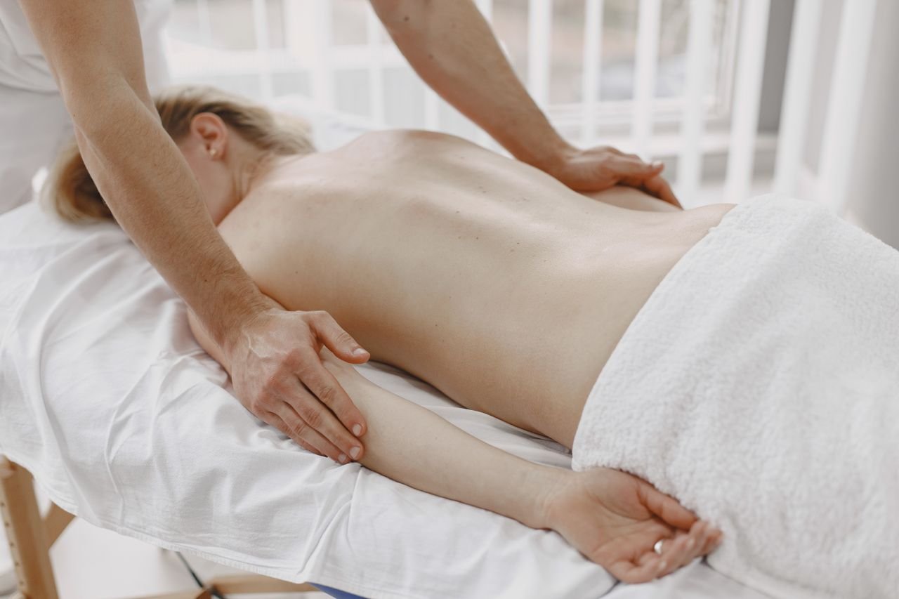 A peaceful back massage session with a focus on relaxation and self-care, ideal for spa and wellness themes.